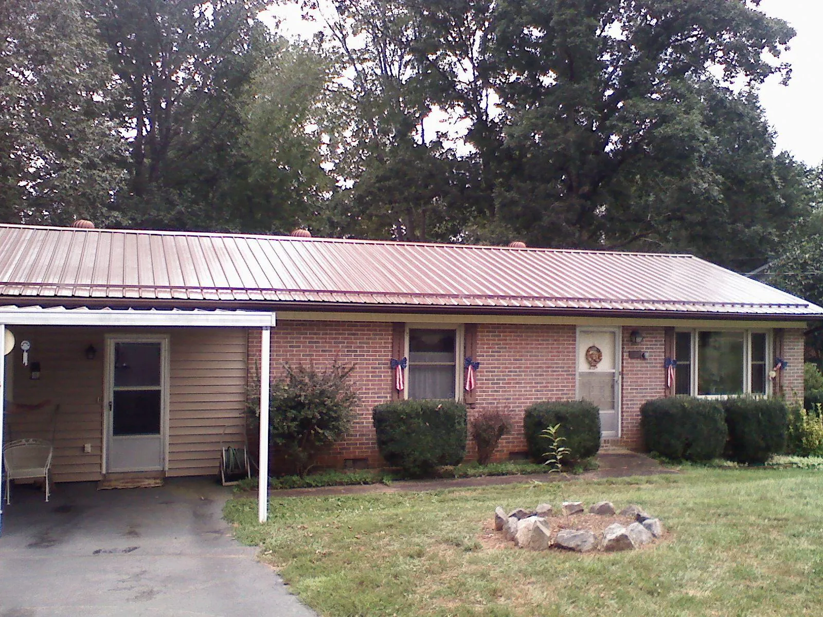 Bronze metal roof and carport on a brick ranch home — Roof Repair work by our crew in Jarrettsville