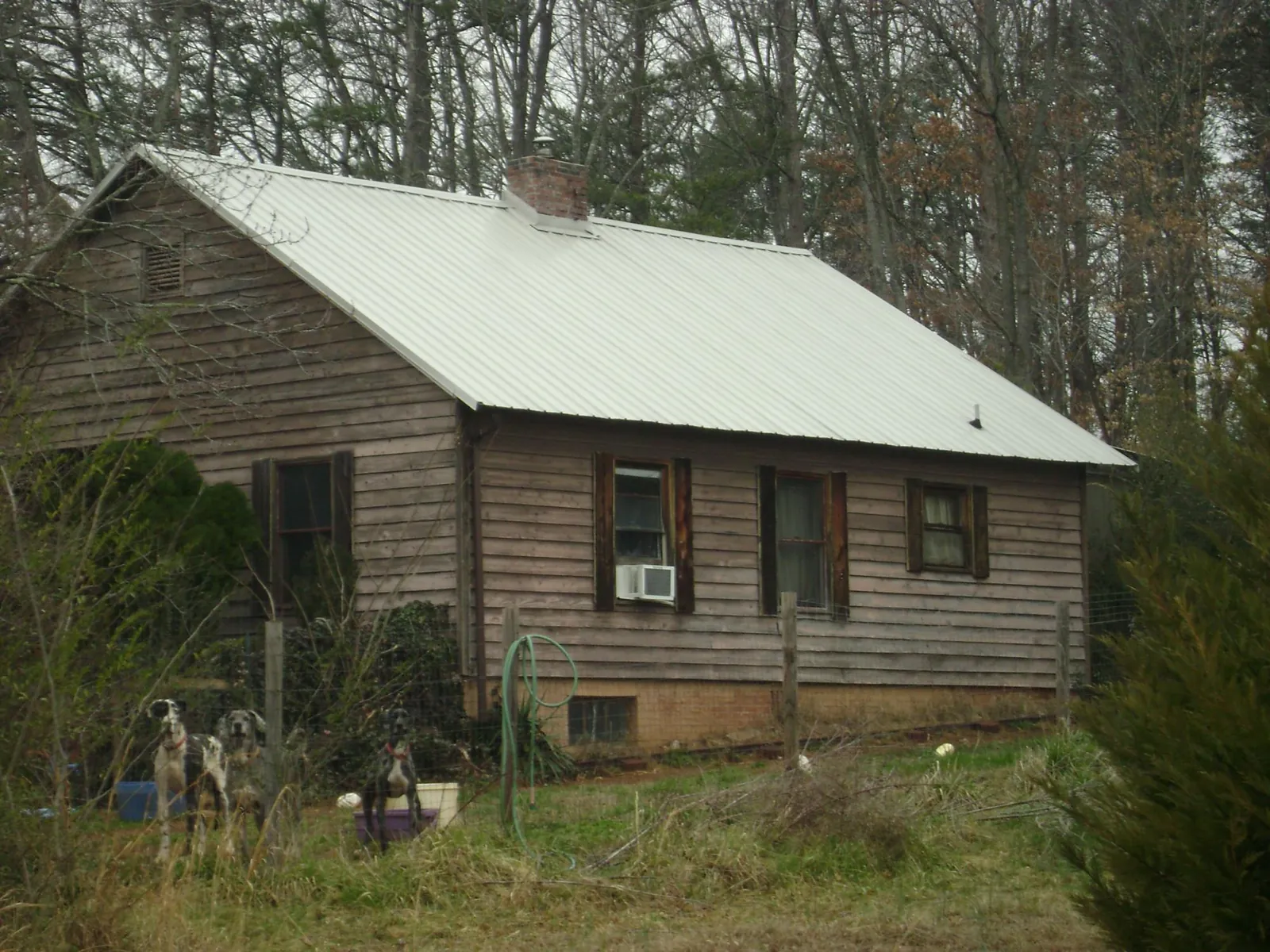 White metal roof on an old wood sided farmhouse, from a Metal Roof Installation job in Jarrettsville